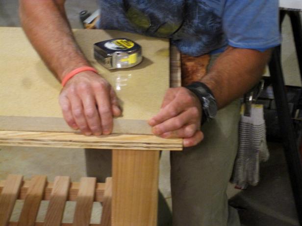 Marc attaches the top of the kitchen cart to the wood frame in this furniture construction projec.t