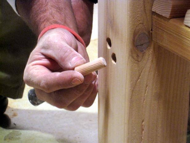 Closeup of wood pieces filling holes of kitchen cart in this furniture construction project.