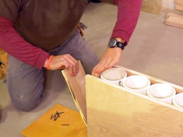 Attaching the bottom part of the wine rack frame with pvc tubes.