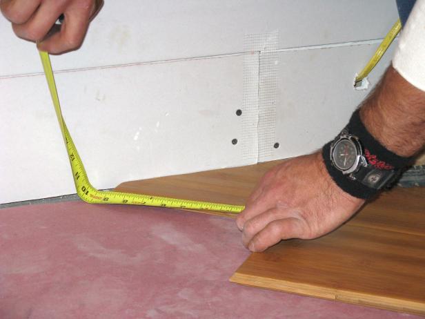Measuring bamboo floor pieces in the floor installation project.