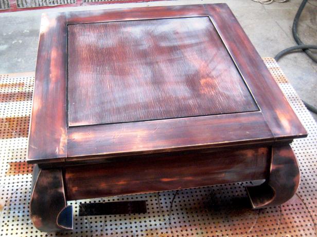 Lightly sand the entire table and legs. You do not need to remove all the finish; in fact, it's better just to smooth out the surface layer.