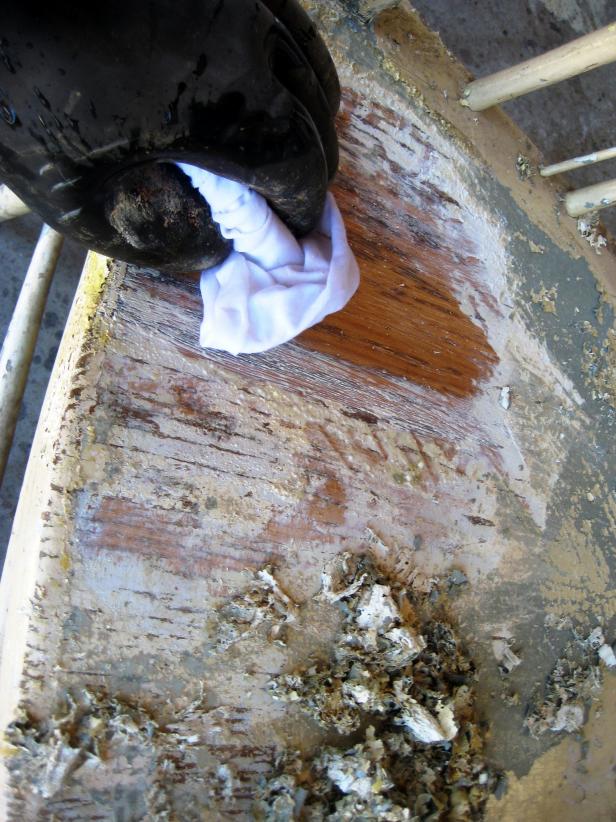 Once you have the majority of the paint off, wipe the chair down with a wet rag and/or steel wool to remove any remaining stripper and paint, and to prevent the stripper from drying on the wood surface.