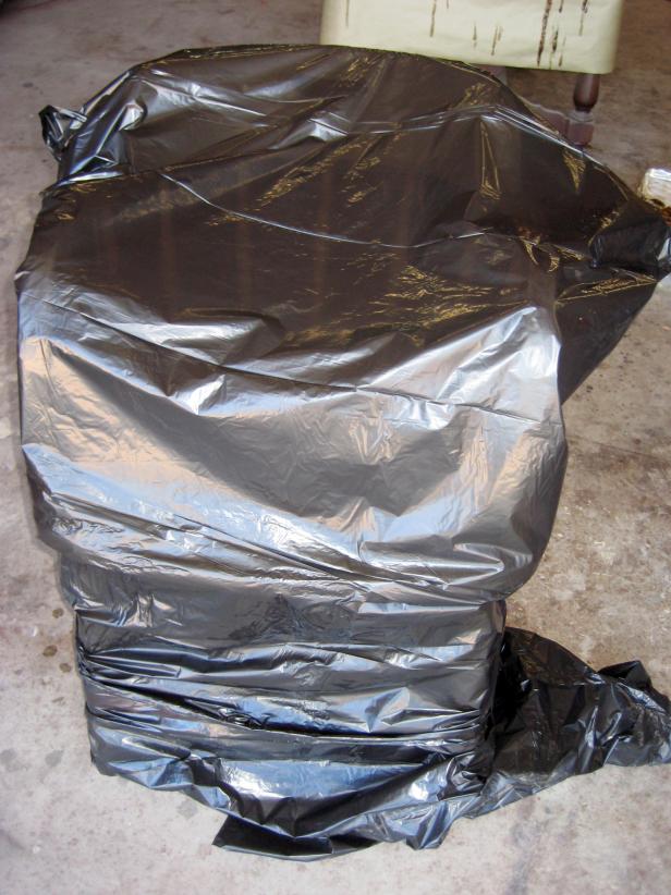 Another method is to apply stripper to the chair, then quickly cover the entire chair with a large garbage bag. This traps in the chemicals and allows the stripper to work more effectively.