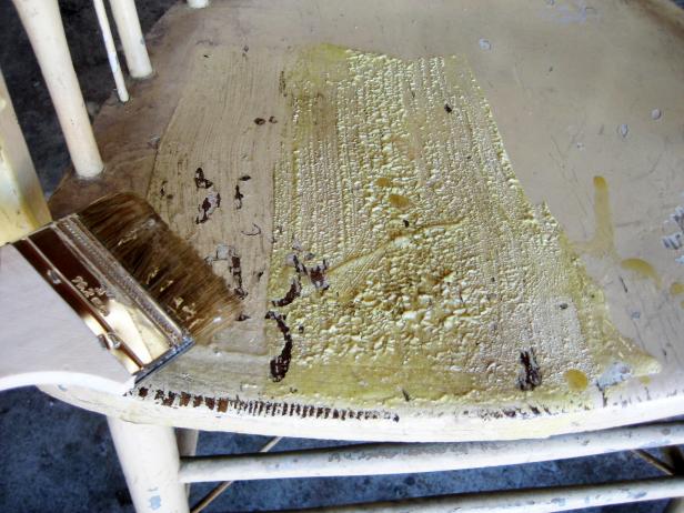 Apply stripper to all painted surfaces with a chip brush – we used an old cooking pot as a reservoir for the stripper.