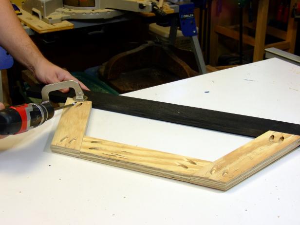 Position the rail/stile assembly five inches from the back end of the runners and attach using glue and 1-1/4-inch pocket-hole screws.