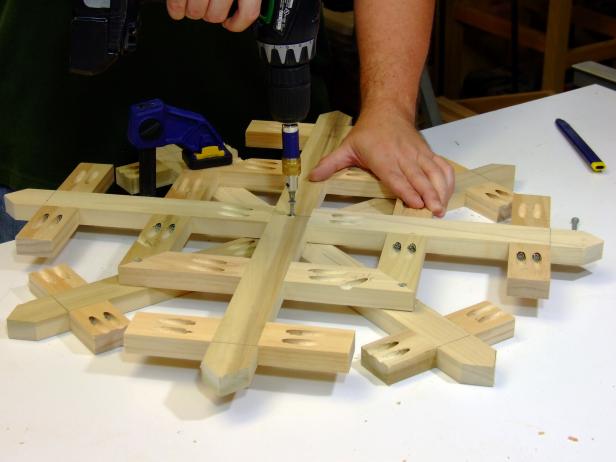 Position the front frame on your work surface with the pocket holes facing up. Position the back frame, pocket holes up, rotated so the long and short points are diagonal to the long and short points of the front frame. Attach using glue and 1-1/4-inch deck screws.