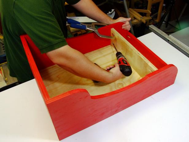 Adjust the length of the divider if necessary to match the inside dimensions of the assembly. Drill two pocket holes on the ends of the divider. Position the divider 4-1/4 inches from the front and attach to the sides using glue and 1-1/4-inch pocket-hole screws.