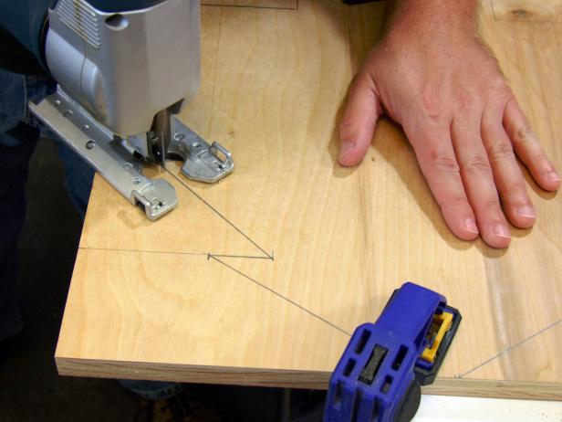 Use a jigsaw to cut out the excess areas on the sides and the center slots.