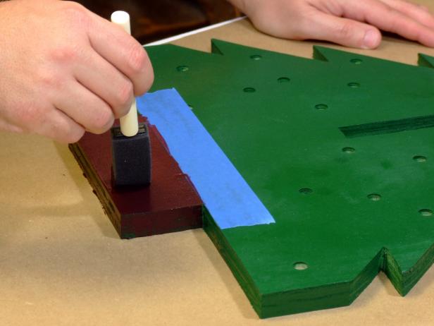 Paint the upper area of the tree sides with dark-green paint, the bottom "trunk" area of the tree sides with brown paint.
