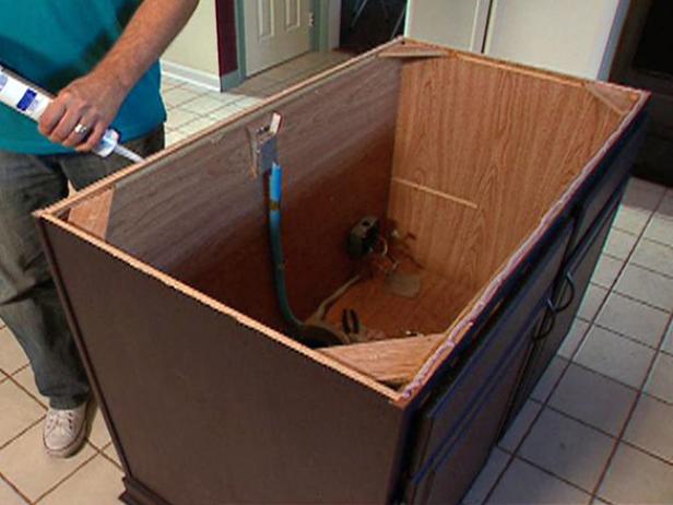 When you are ready to set the dry countertop, apply a bead of silicon cault to the edge of the cabinet.