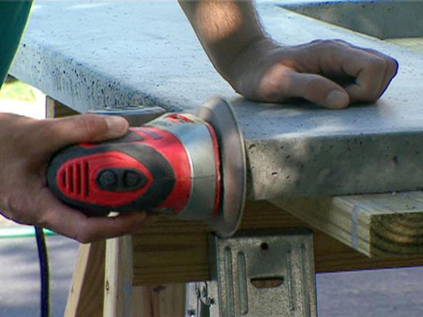 Sand evenly, checking the smoothness with your hand. When done, wipe the slab with a damp rag to remove any loose grit and concrete dust.
