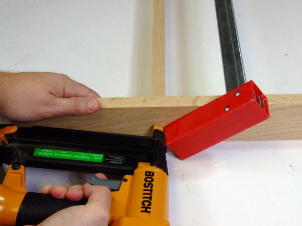 Complete the rails for the pot rack by positioning the remaining support rail centered and flush with one edge of the two end rails. Attach using glue and #17 x 1-1/2-inch brads