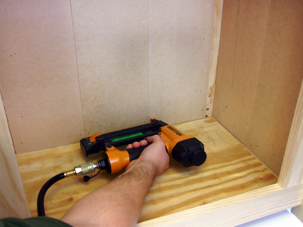 Apply glue to the inside of the back side rail assembly (rails and stiles), slide three interlocked pieces of wainscot into the assembly (flush with the bottom) and attach using 5/8-inch brads (Image 4).
