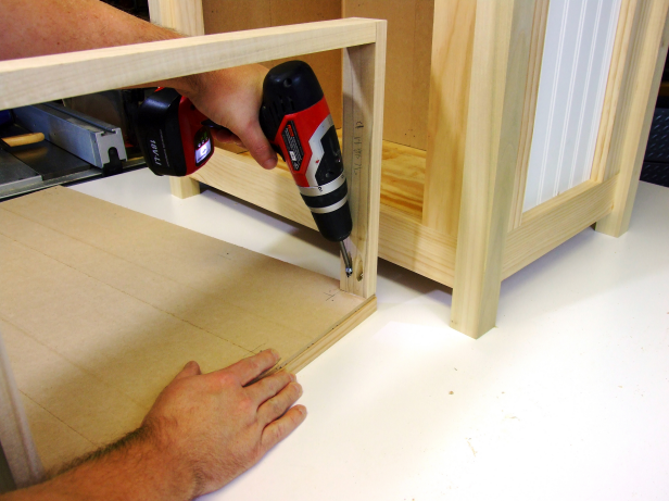Position the assembly, flush with the bottom of the door assembly and centered on the door assembly, and attach using glue and 1-1/4-inch pocket-hole screws