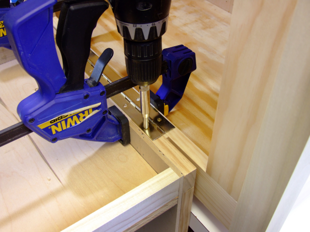 Use a paint stirrer as a spacer, and clamp the door assembly centered on the door opening and attach using the included screws as shown in Image 3.
