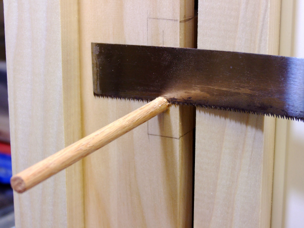 Apply glue to the inside of the screw holes for the hinge blocks, insert a 5/16-inch dowel, and cut the dowel flush using a flush-cut handsaw.