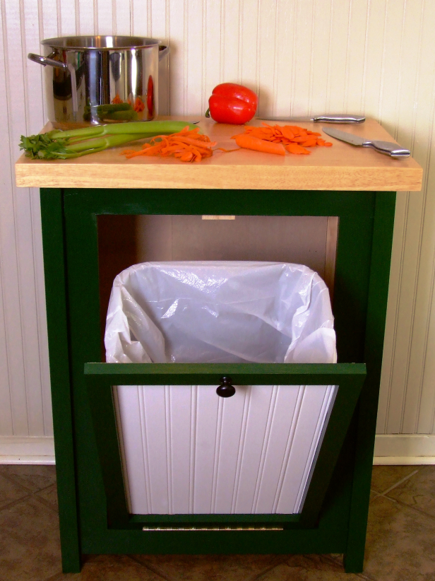 Hide your trash can in style with this tilt-open-door cabinet.
