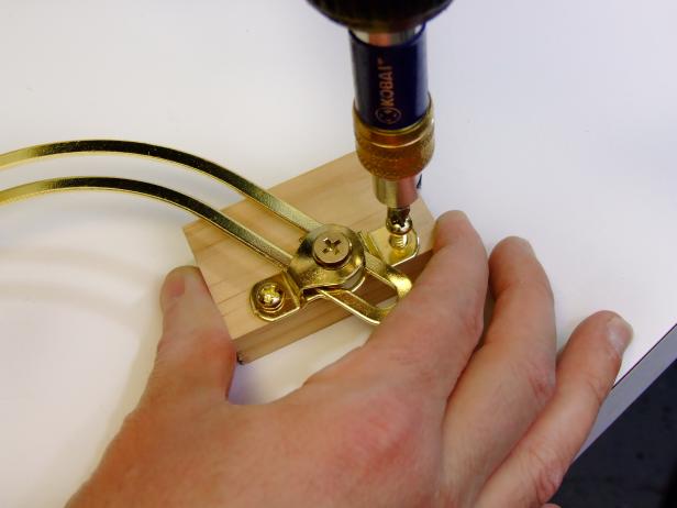 Attach the friction lid supports centered and against the back edge of the hinge blocks as shown in Image 4.