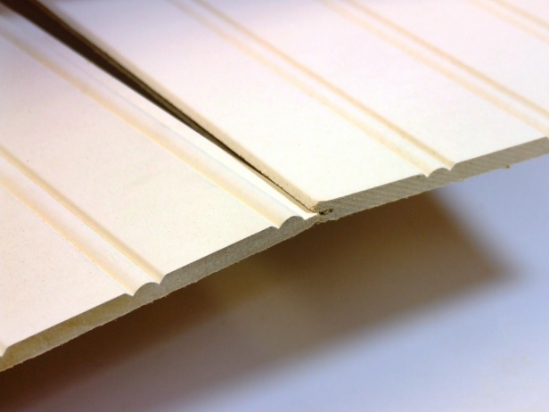 Interlock two pieces of the wainscot for the side panels, as shown in Image 1.