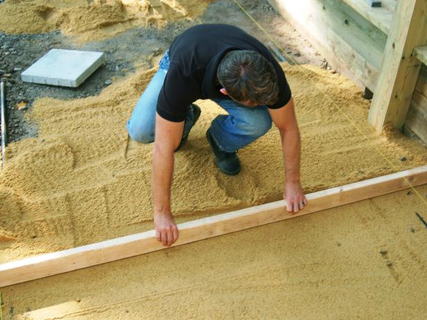 Remove the guides and fill in the remaining space with sand.