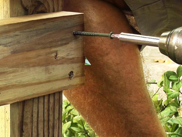 Attach the rails to the posts using two 3-inch galvanized steel drive screws.