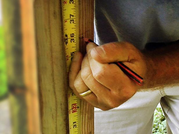 From the base of each post, measure up 12 inches for the lower rail and 36 inches for the top rail. Make a mark at 90 degrees on the back of the posts.