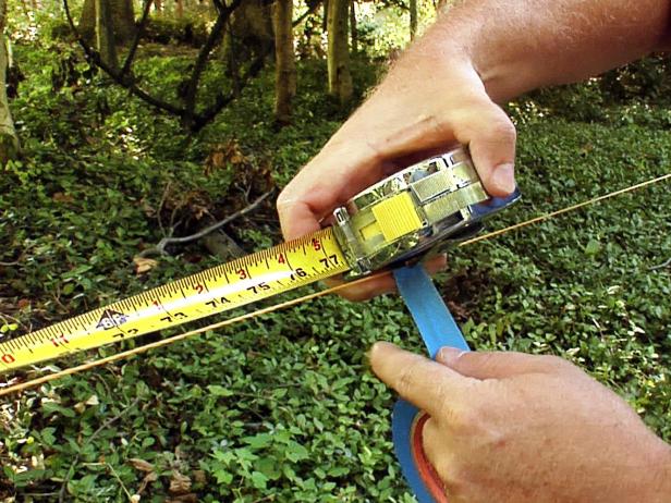 Set the interior posts using the string to divide the 48-foot span into six equal sections 8 feet apart, marking each on center with a piece of masking tape placed on the string.