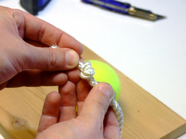 Cut four, 24-inch lengths of 1/4-inch nylon rope and tie a knot on each end.