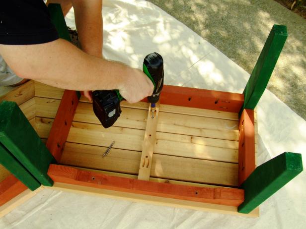 Use a drill to secure the bench slats for the top of the bench.