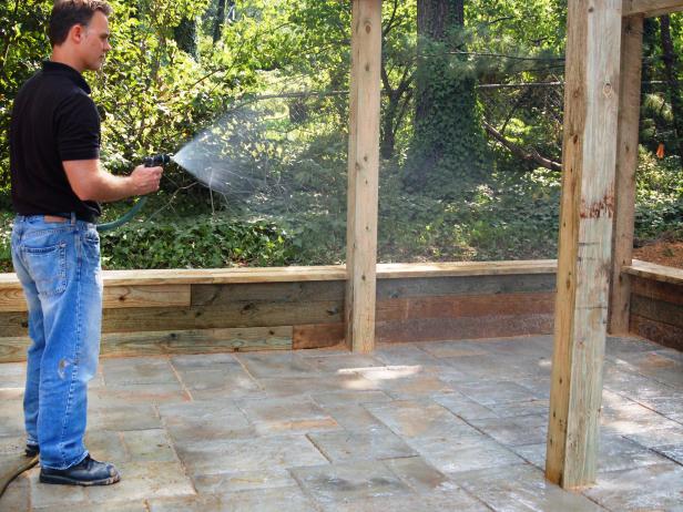 To pack the sand into the joints, spray the patio with water from a garden hose.