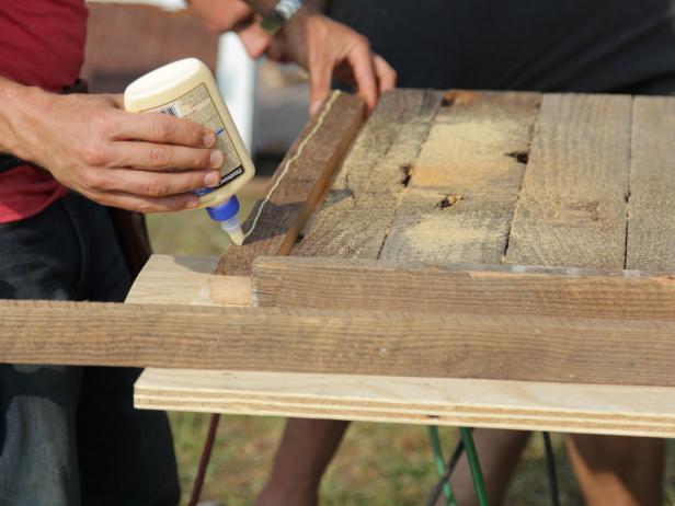 Rip extra pieces of lumber in half to create 2" by 1" edge trim. Choose miter cut or butt jointed corners. Measure, cut, and apply glue to trim.