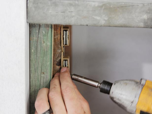 Using a drill, install a magnetic closure to keep the dry bar door closed.