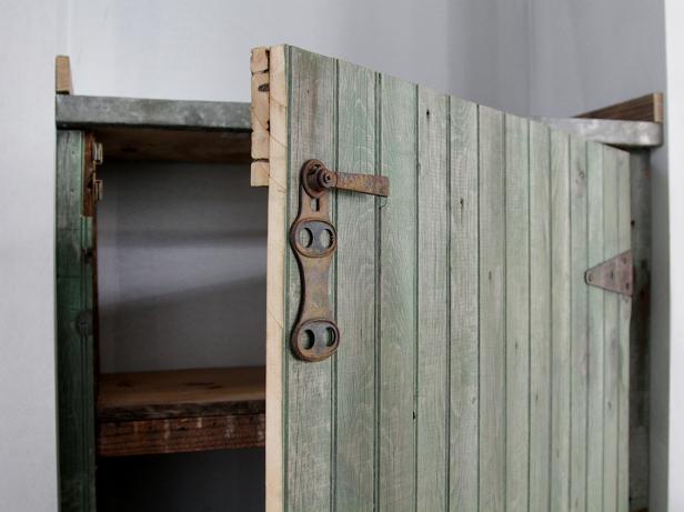 Use an old, rusty latch to complete the rustic look of this dry bar.
