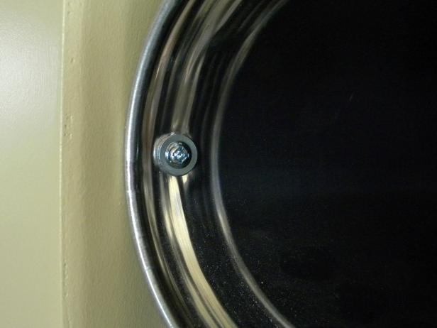 Insert the first screw to secure the rack to the wall. For a strong attachment, sink the screws into a wall stud. Do the same for each duct opening .