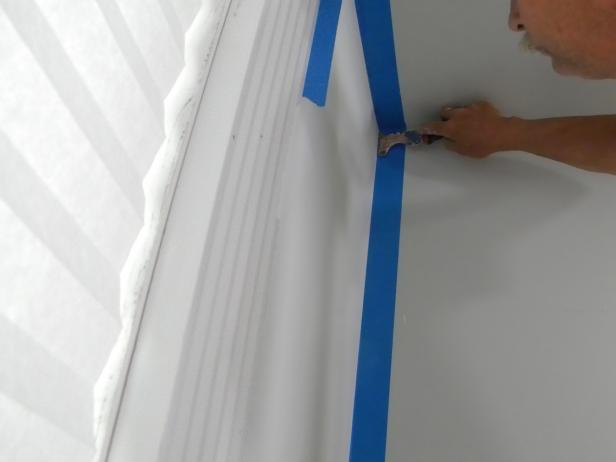 Use a putty knife or 5 in 1 painter's tool to "force seal" the tape to the surface. Vacuum and clean up any paint dust residue.