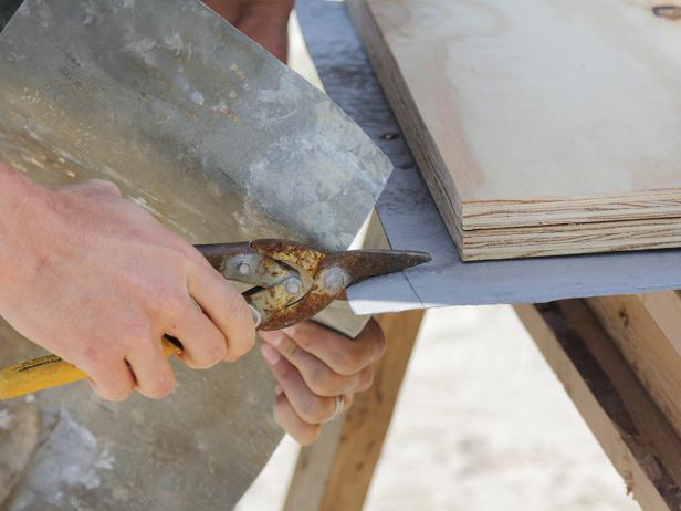 To wrap the edges and corners with galvanized steel roofing, use tin snips to reduce "fish hooks" on the edges.