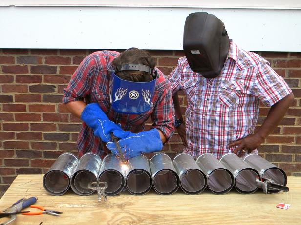 Create a half frame jig by screwing two 2x4s into the work table. When the ducts are aligned side by side in the jig, the tops will be resting against the jig and the sides parallel to each other. Hold ducts together with metal clamps.