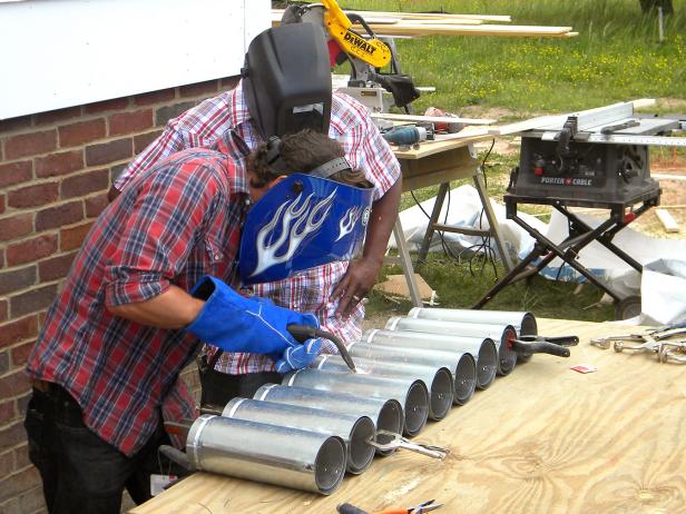 Working down the line and on one side only, tack-weld the ducts together. Place four or five tack welds between each duct. The top tack weld should be about four inches down from the top end of the duct.