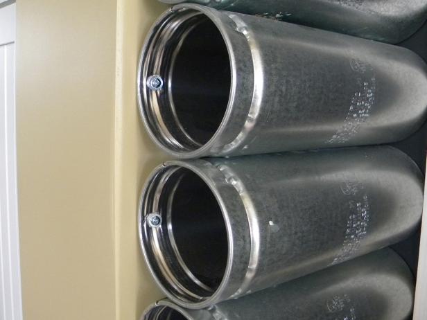 The attachment screws must firmly connect the rack to the wall or cabinet side. If the wall-mounted rack is attached to drywall, make certain the screws hit wall studs. If not, drill pilot holes and insert ribbed wall anchors to secure the screws.