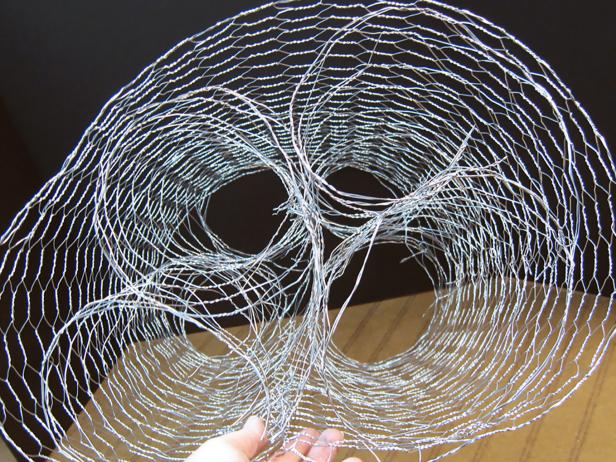 Twist the cell ends to the back to hold shape. Create two of these so you'll have four cylinders. Wrap a 42-inch piece of the 1-inch cell chicken wire around the two pieces. Twist the ends at the seams to hold.