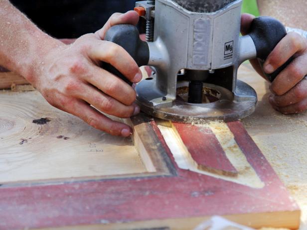 With the frame screwed together, scribe the face in pencil with the desired shape of the imbedded stamped tin. Insert a straight cutting router bit into the router.