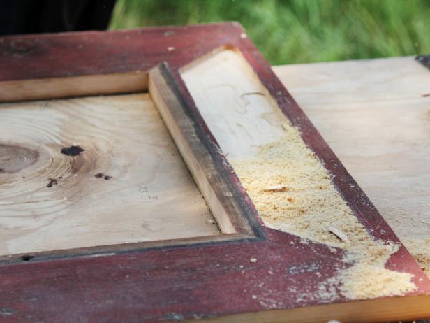 Clamp the wooden frame onto a solid surface and carefully route out a 1/2" deep pattern for the stamped tin insert. Repeat the routing process on all four faces of the frame.