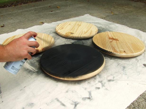Apply spray paint to both sides and edges of three of the body segments. Apply spray paint to one side, the edge, and a 3-inch wide strip on the other side of the fourth body segment.
