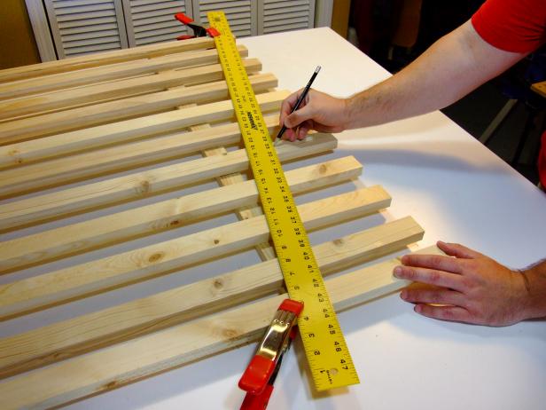 Position the assembly with the rails facing down. Use a long ruler or straight edge as a guide for marking a line from the bottom of the bottom rail on the left picket to the bottom of the far right picket.