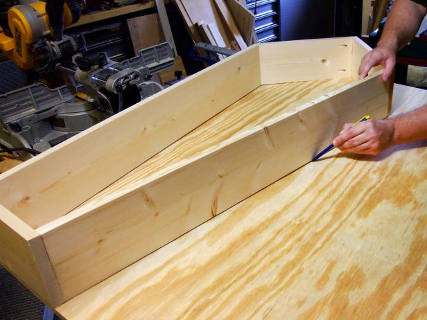 Position the base assembly on top of the sheet of plywood and mark the outside edges of the assembly on the plywood