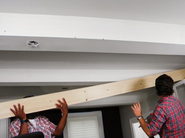 Bring the full length side piece up to the girder. Adjust the side cut wood, holding it against the end walls.
