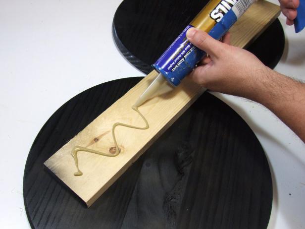 Apply construction adhesive to the unpainted face of the base and attach using #18 x 1-inch wire brads.