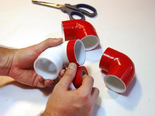 Cut 20 legs from PVC pipes per the project parts list using either a miter saw or a hack saw. Wrap the 90-degree elbows and 45-degree elbows with red electrical tape.