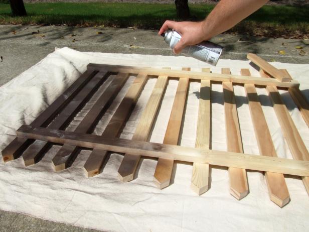 Place the assembly on a drop cloth and apply brown spray paint. Position the fence in the desired spot in your yard and press the stake into the ground.