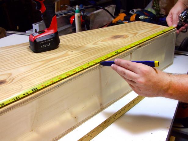 Position the lid flush with the edges of the assembly and mark the center of the left side of the lid.